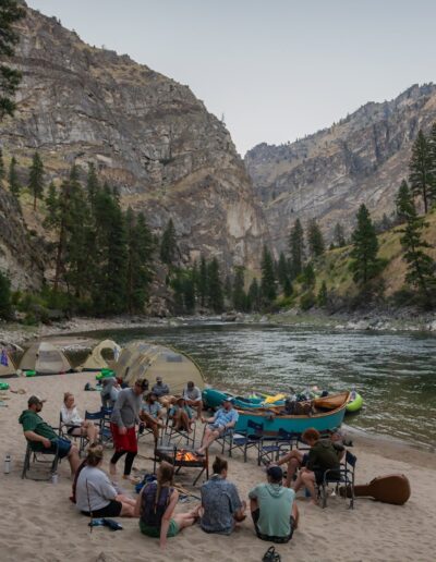 sitting on a beach after river rafting in the late season